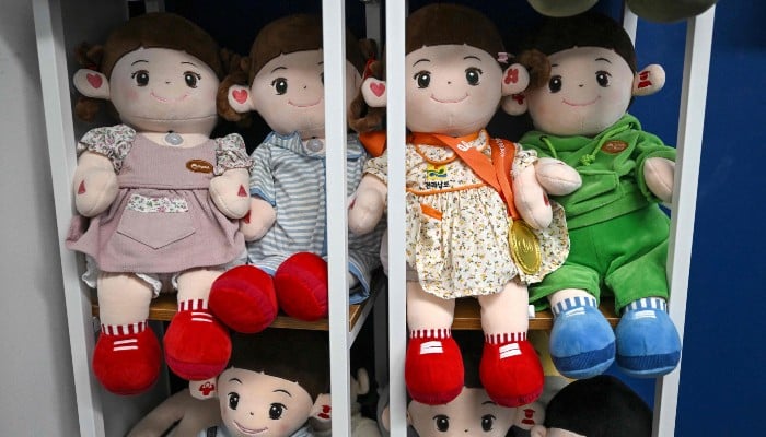 This picture taken on May 6, 2026, shows Hyodols AI-powered healthcare dolls designed for elderly people displayed at the companys headquarters in Anyang. — AFP