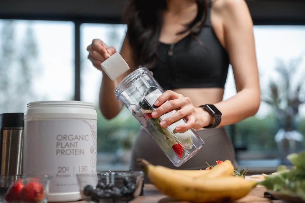 woman making protein smoothie at home woman making protein smoothie at home