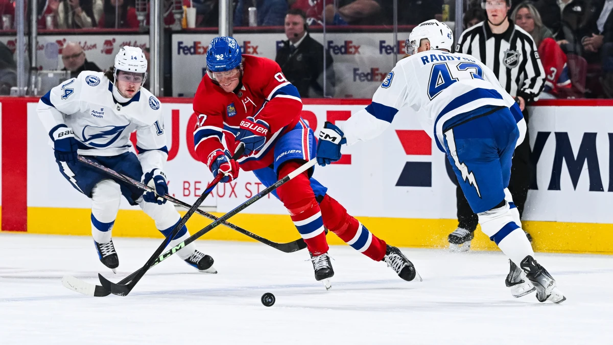 Tampa Bay Lightning center Conor Geekie (14) and defenseman Darren Raddysh (43) defend the puck against Montreal Canadiens right wing Patrik Laine (92) during the third period at Bell Centre.