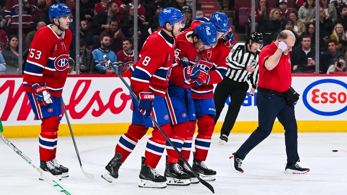 Montreal Canadiens center Alex Newhook (15) gets escorted off the ice after sustaining an injury against the Dallas Stars during the second period at Bell Centre.
