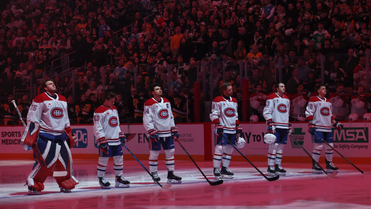 The Montreal Canadiens starting line up (L to R) including goaltender Jakub Dobes (75) and right wing Cole Caufield (13) and center Nick Suzuki (14) and defenseman Mike Matheson (8) and defenseman Noah Dobson (53) and right wing Zachary Bolduc (76) stand for the Canadian national anthem against the Pittsburgh Penguins at PPG Paints Arena.