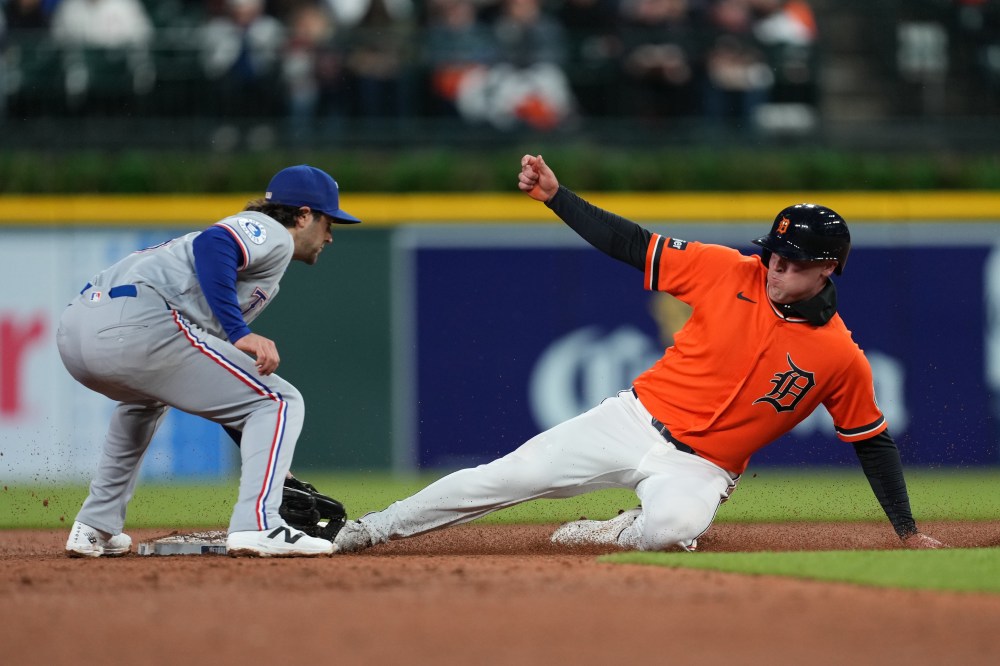 Detroit Tigers' Kerry Carpenter, right, steals second base under the tag of Texas Rangers second baseman Josh Smith, left, during the fifth inning of a baseball game Friday, May 1, 2026, in Detroit. (AP Photo/Paul Sancya)