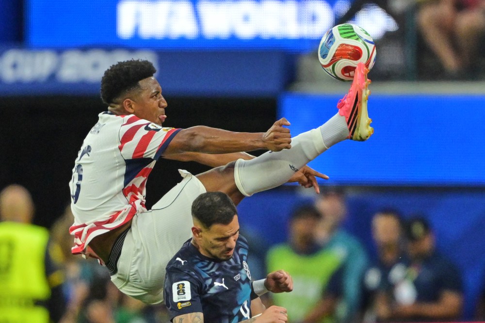 United States' Alex Freeman, top, reaches for the ball over Paraguay's Antonio Sanabria during the World Cup Group D soccer match in Inglewood, Calif., near Los Angeles, Friday, June 12, 2026. (AP Photo/Jayne Kamin-Oncea)