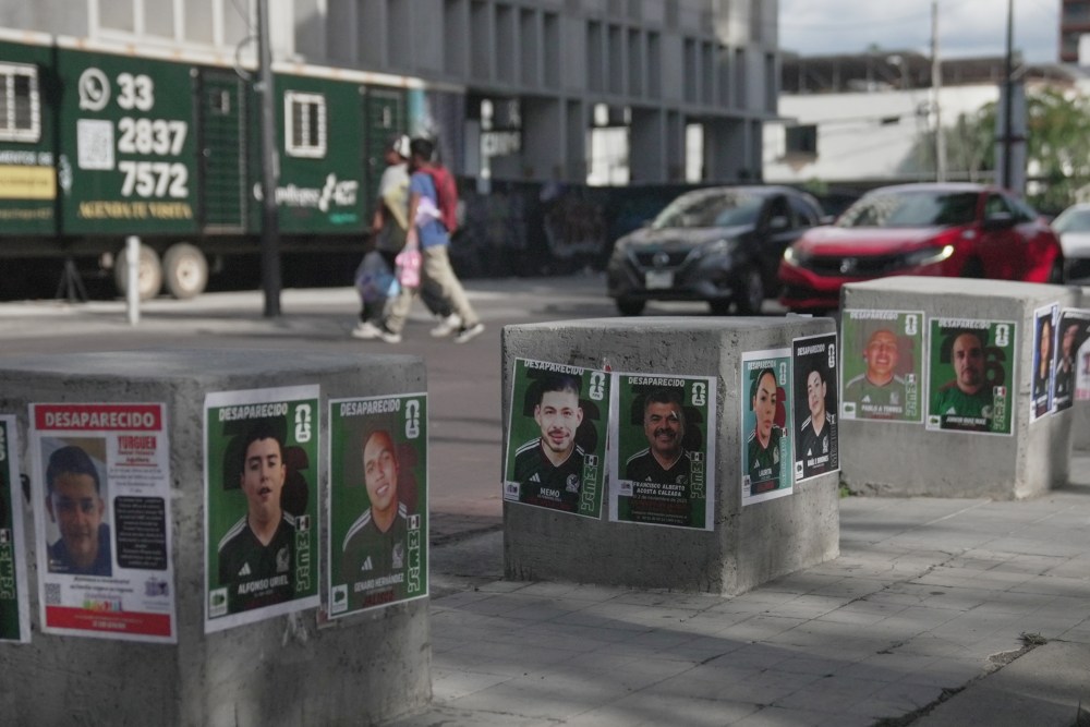 Posters of missing people wearing Mexican national soccer team jerseys to resemble World Cup sticker album cards are posted on a street in Guadalajara, Mexico, Tuesday, June 16, 2026. (AP Photo/Martin Silva)