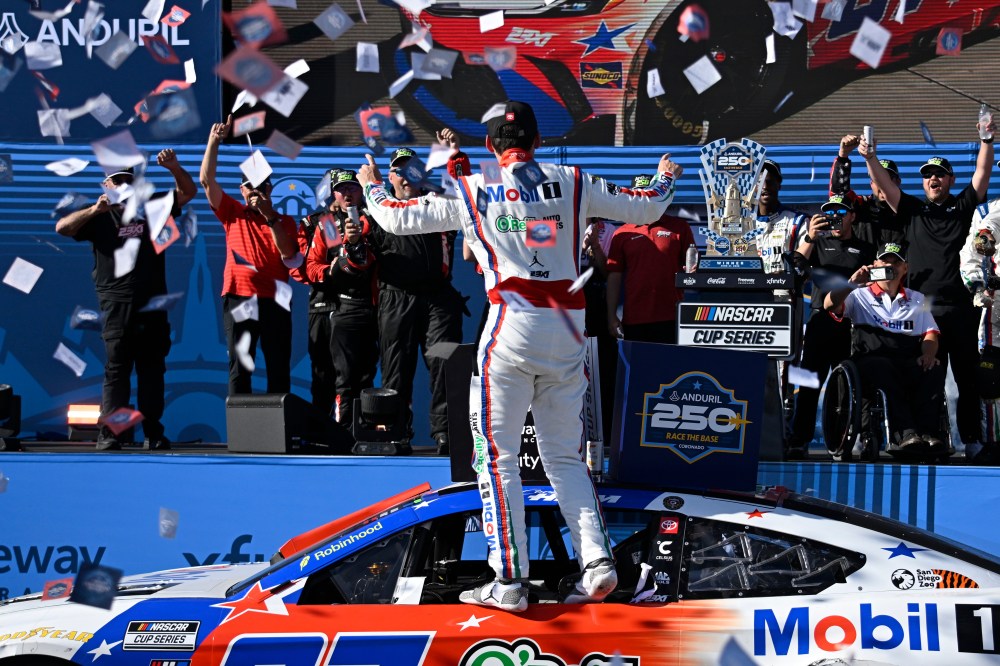 Cory Heim, center, celebrates in Victory Lane after winning a NASCAR Cup Series auto race, Sunday, June 21, 2026, in Coronado, Calif. (AP Photo/Denis Poroy)