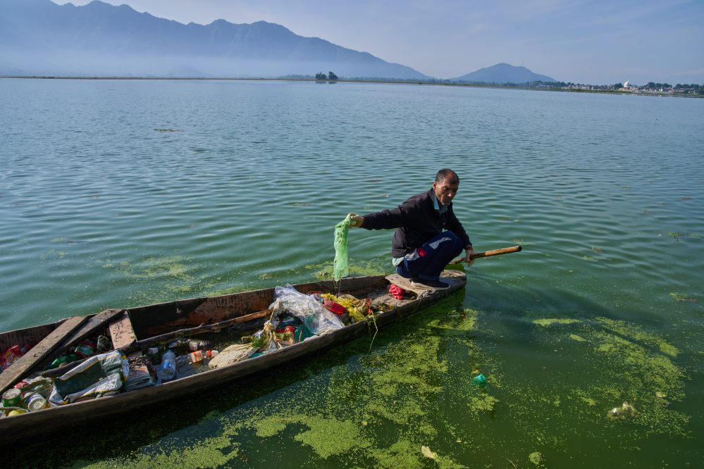 Mohammad Amin, a Kashmiri laborer employed by a nonprofit organization that collects garbage floating on Dal Lake, works on the outskirts of Srinagar, Indian controlled Kashmir, Monday, May 4, 2026. (AP Photo/Dar Yasin)