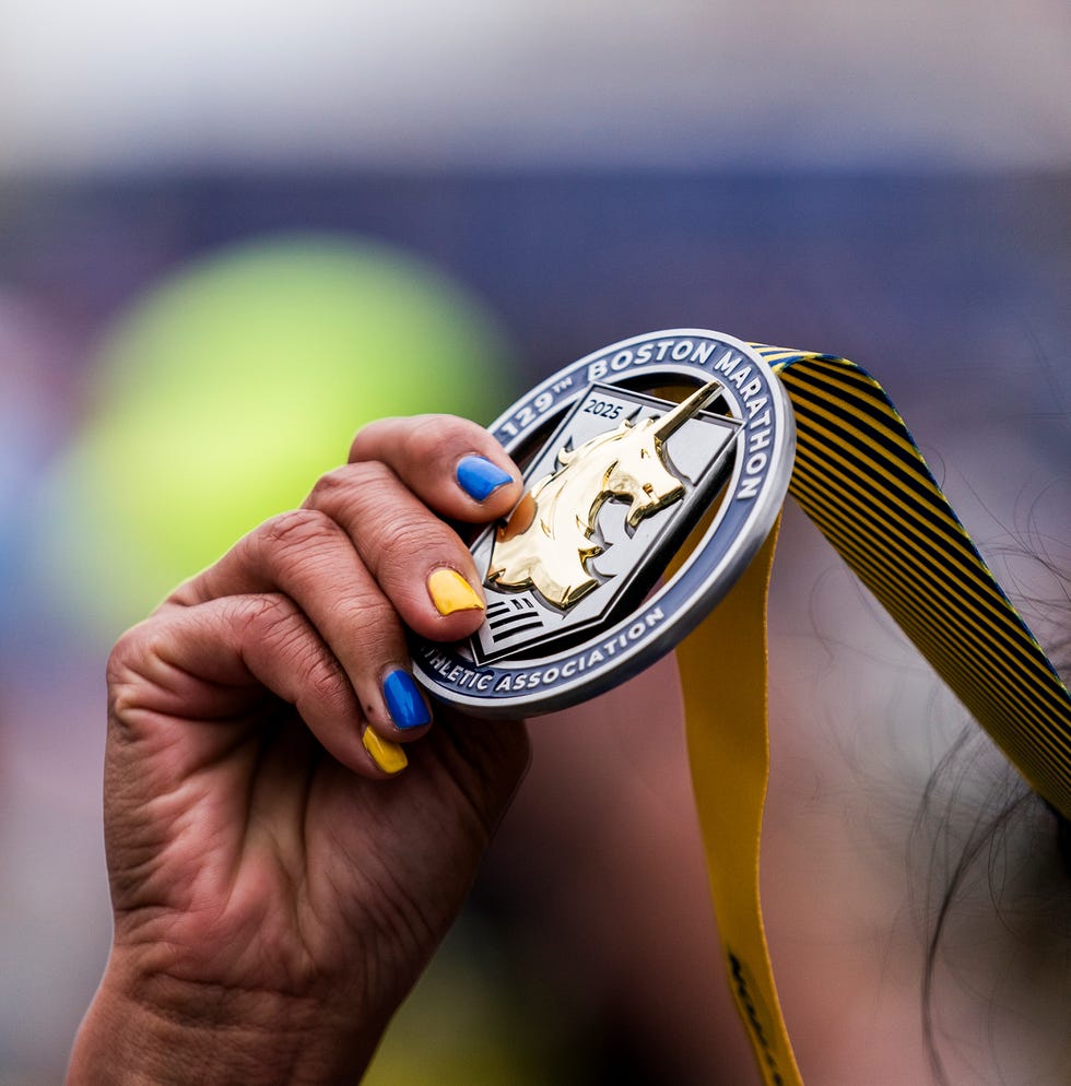 RWD Person holding a medal for the Boston Marathon.