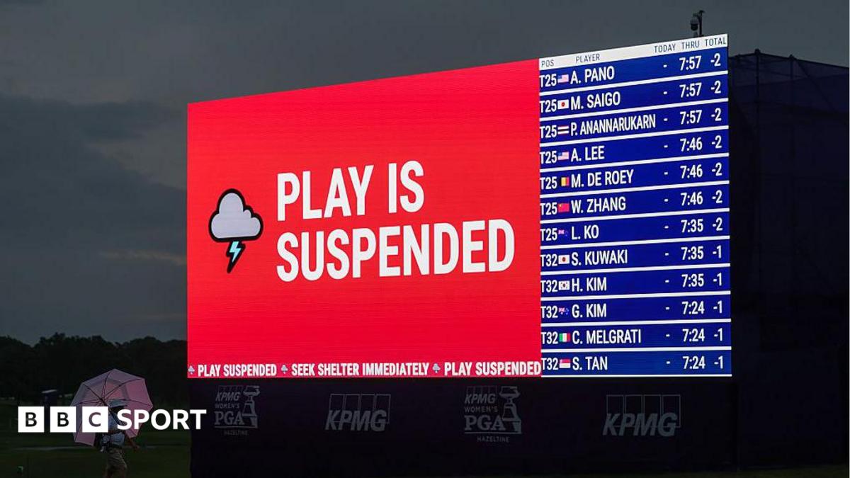 Weather warning messages are displayed on LED boards around the course as play is suspended ahead of the final round of the Women's PGA Championship 2026 at Hazeltine National Golf Club