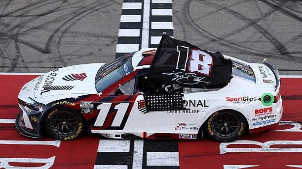 Denny Hamlin Honors Kyle Busch While Raising a Flag after his Michigan Win. (Photo by Brett Farmer/Getty Images)(Photo by Brett Farmer/Getty Images)