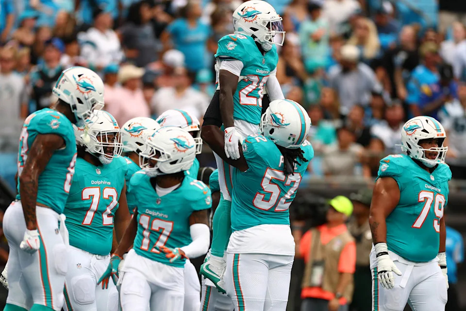 CHARLOTTE, NORTH CAROLINA - OCTOBER 05: De'Von Achane #28 and Patrick Paul #52 of the Miami Dolphins in the game against the Carolina Panthers at Bank of America Stadium on October 05, 2025 in Charlotte, North Carolina. (Photo by Grant Halverson/Getty Images)