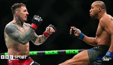 Ciryl Gane delivers a low kick to Tom Aspinall during their bout in UFC 321 in Abu Dhabi