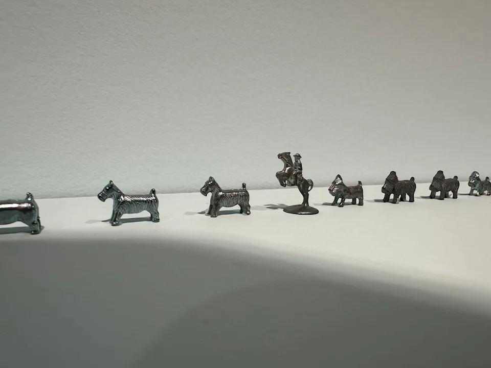 Various Monopoly playing pieces, or tokens, are on display throughout Ghazaleh Avarzamani's exhibit at Contemporary Calgary. The man on horseback, which the cowboy butter sculpture is based on, appears frequently.
