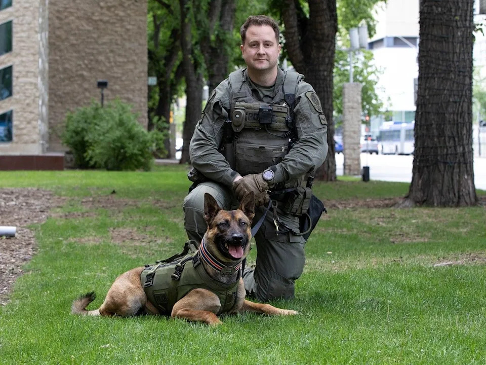 New Edmonton Police Service members Const. Mike Flavell and police service dog Pablo pose for a photo before taking part in the graduation ceremony for EPS recruit Training Class 165 at city hall on Friday, June 12, 2026. 34 new police officers and two canines graduated during the ceremony.