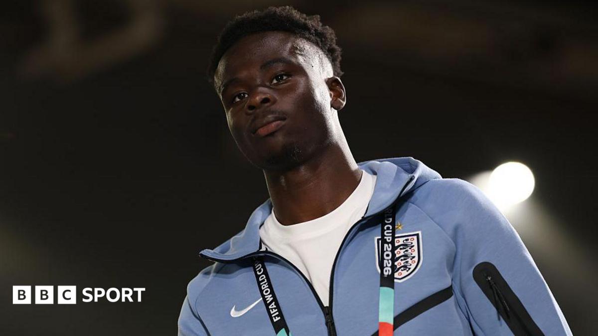 Bukayo Saka in a pale blue England tracksuit