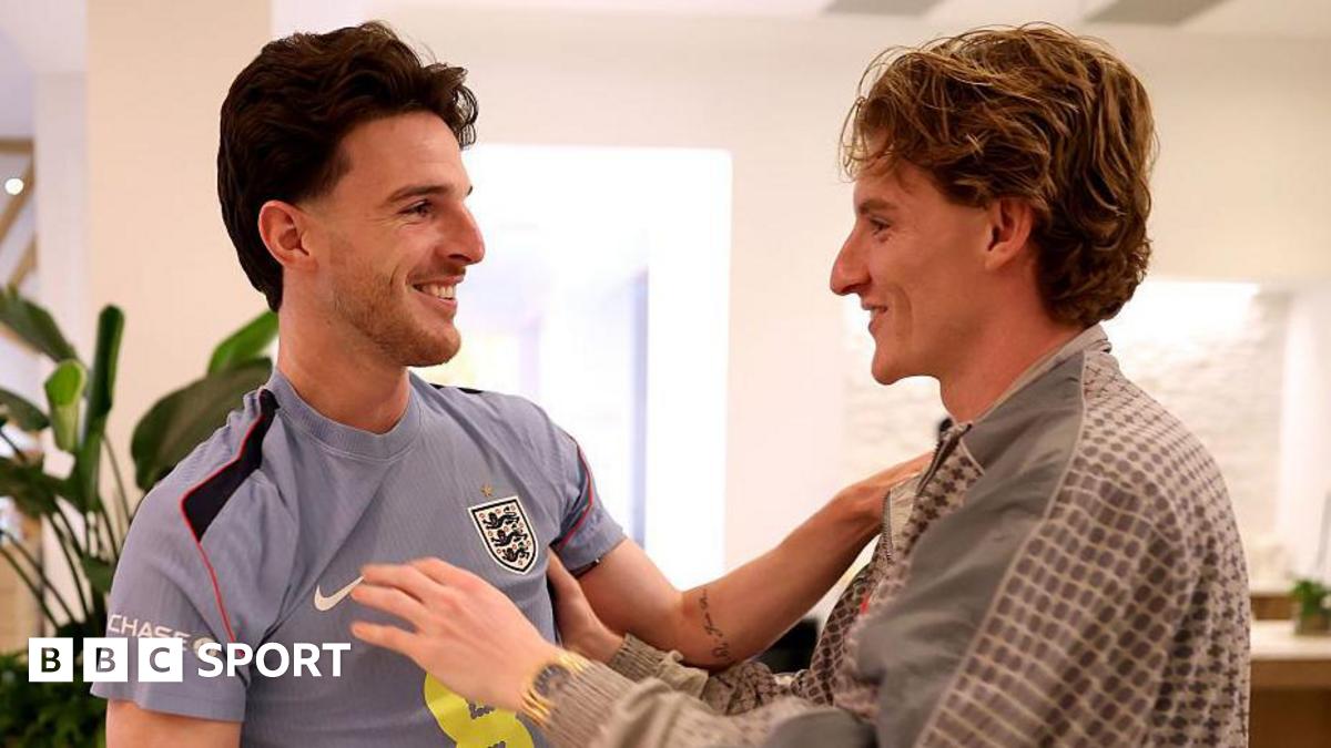 Anthony Gordon greets England team-mate Declan Rice as he arrives in Florida before the 2026 World Cup