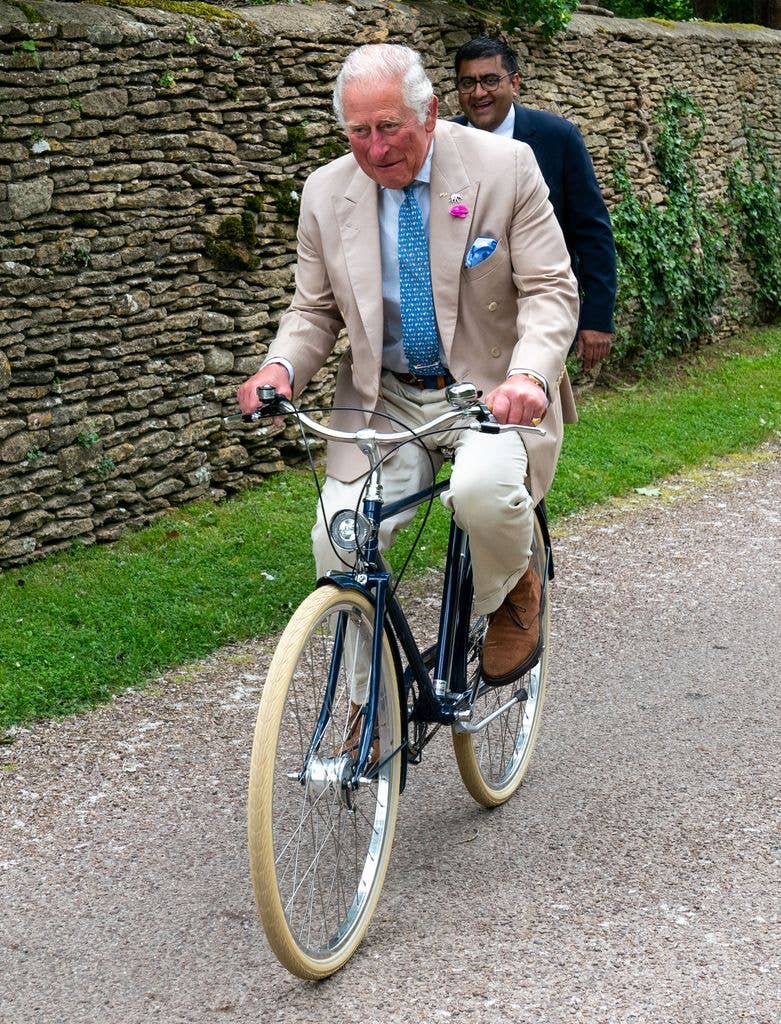 Charles riding a bicycle for the Palaces on Wheels cycling event in 2021