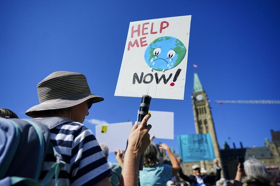 People participate in a climate protest on Parliament Hill in Ottawa on Friday, Sept. 15, 2023. THE CANADIAN PRESS/Sean Kilpatrick - The Canadian Press
