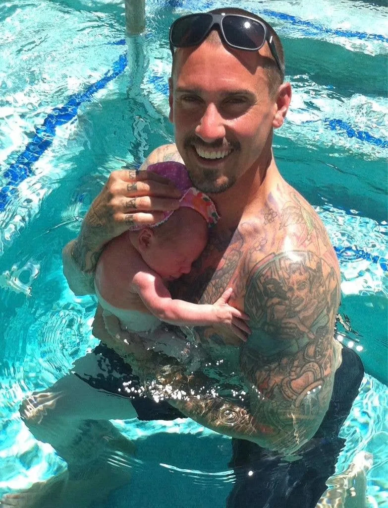 Carey Hart holds his daughter with Pink, Willow Sage Hart, as a newborn in a pool, throwback shared on Instagram