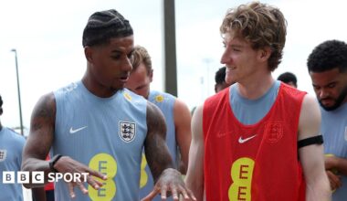Marcus Rashford and Anthony Gordon of England interact as they walk out for a training session