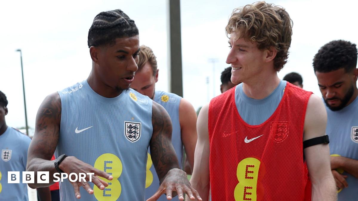 Marcus Rashford and Anthony Gordon of England interact as they walk out for a training session