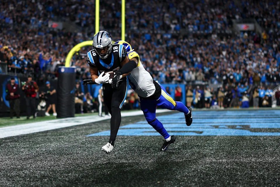 CHARLOTTE, NORTH CAROLINA - JANUARY 10: Jalen Coker #18 of the Carolina Panthers catches a pass to score a touchdown as Kam Curl #3 of the Los Angeles Rams defends during an NFL wild card playoff football game at Bank of America Stadium on January 10, 2026 in Charlotte, North Carolina. (Photo by Kevin Sabitus/Getty Images)