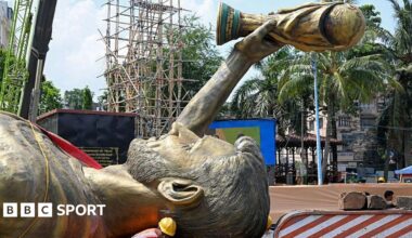 Lionel Messi's 70ft statue laid horizontally being transported.