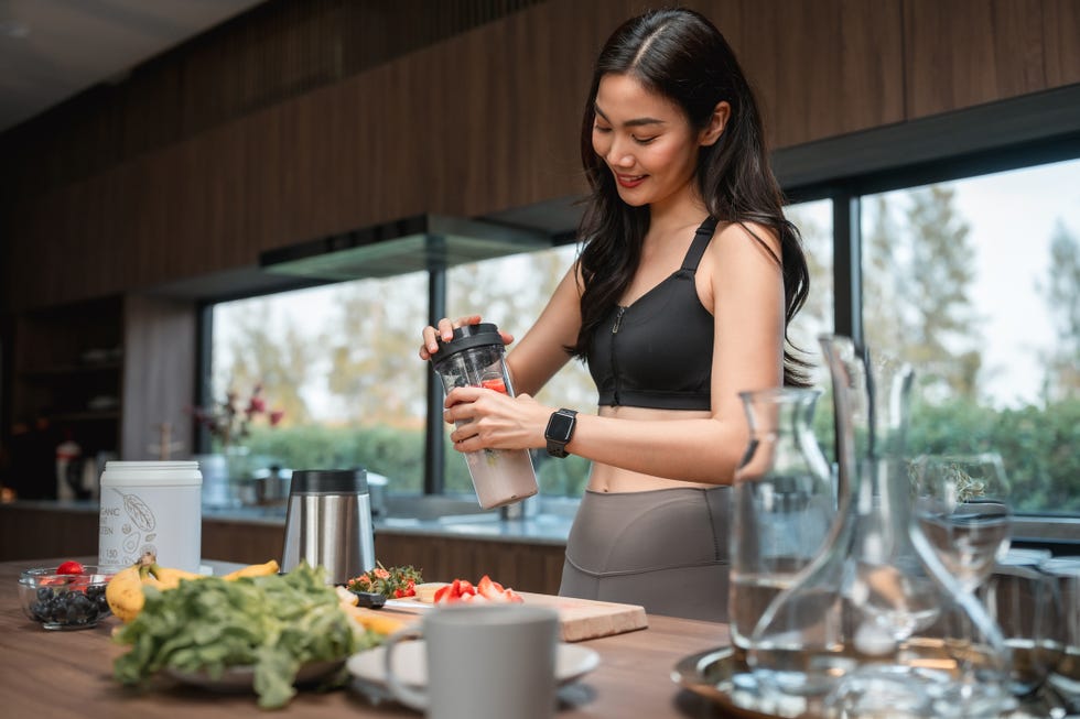 woman making protein smoothie at home woman making protein smoothie at home