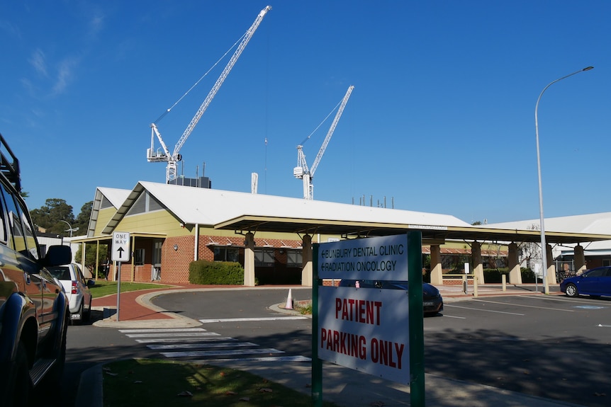 Bunbury Regional Hospital in the foreground and two large cranes in the background