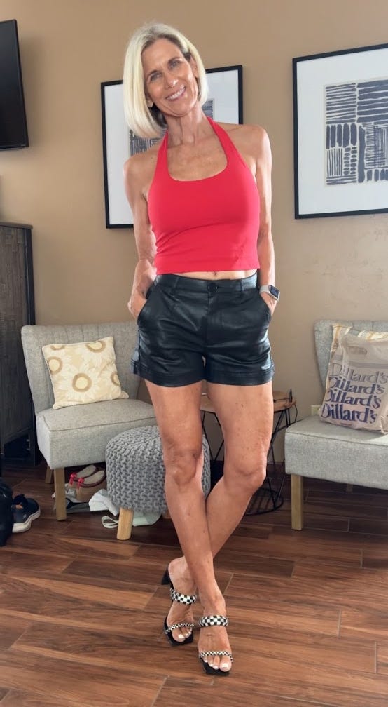 Woman posing in a stylish outfit in a living room setting