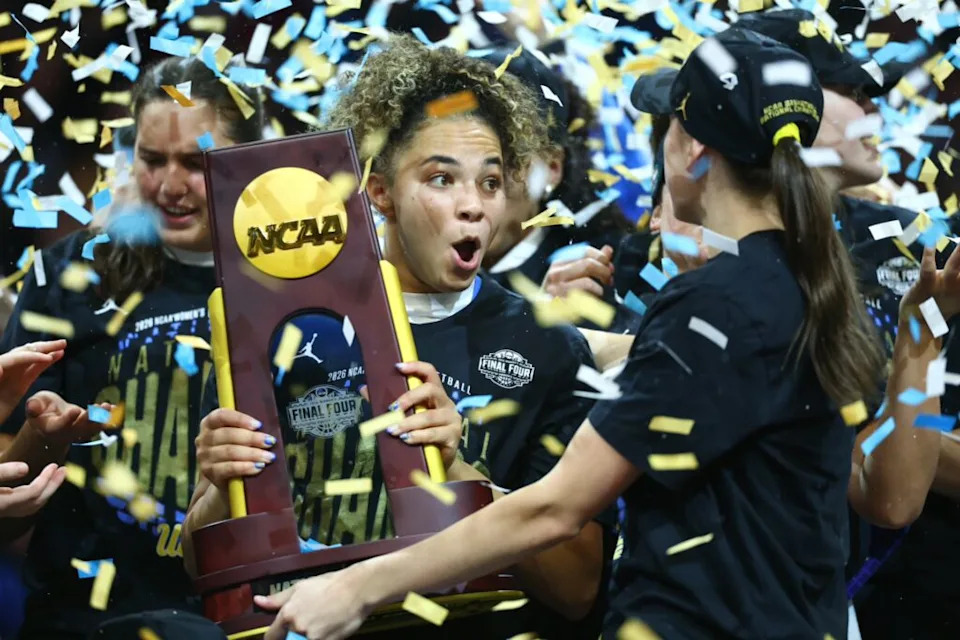 Apr 5, 2026; Phoenix, AZ, USA; UCLA Bruins guard Kiki Rice (1) celebrates with the trophy after the National Championship game against the South Carolina Gamecocks of the women's 2026 NCAA Tournament at Mortgage Matchup Center. Mandatory Credit: Mark J. Rebilas-Imagn Images