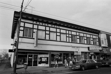 1985: 6181-6191 Fraser St. Signs for Cottage Cleaners, Fraser Variety and Mennonite Thrift Store are visible.