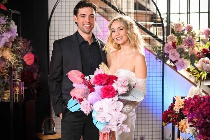 A man and woman posing for a wedding portrait.