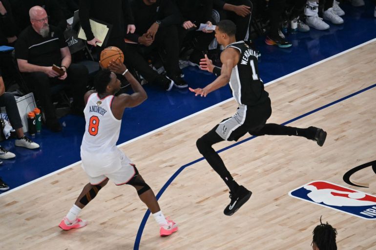 San Antonio Spurs' French forward-center #01 Victor Wembanyama jumps as Nicks' British-US player #08 OG Anunoby prepares to throw during Game Three of the NBA Finals 