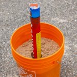 Firework in bucket with sand for safety
