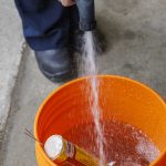 soaking used firework in a bucket of water