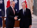  Australian Prime Minister Anthony Albanese shakes hands with Canada's Prime Minister Mark Carney during a ceremonial welcome at Australian Parliament House on March 5, 2026 in Canberra, Australia.  