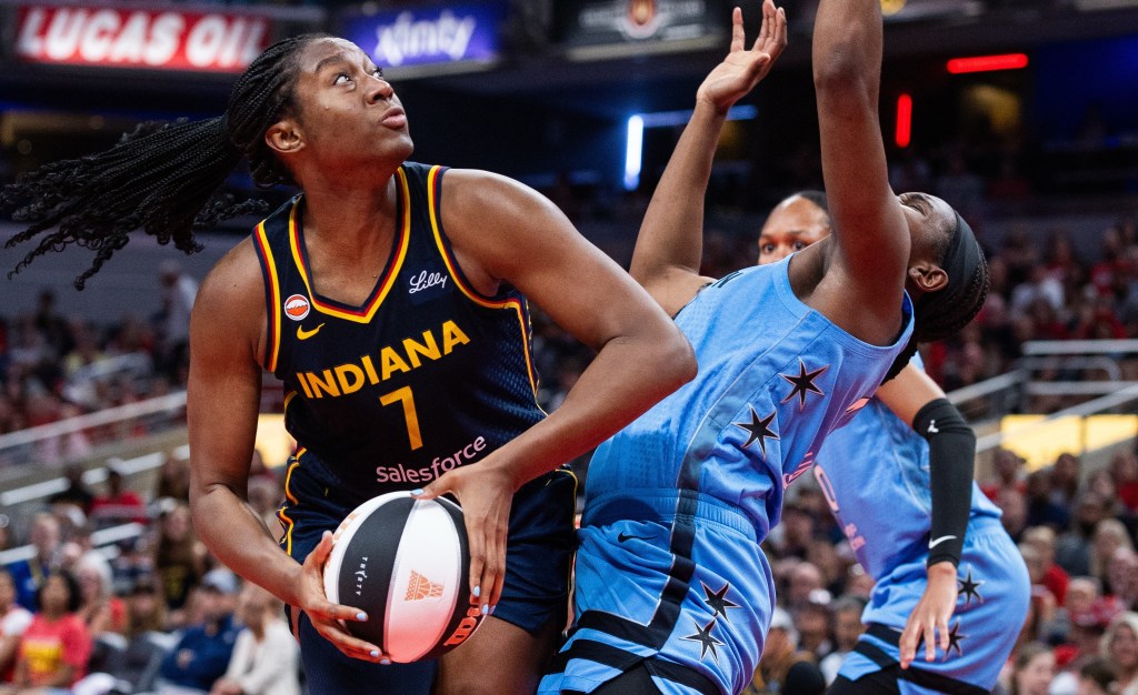 Aliyah Boston, who had 34 points and 12 rebounds, looks to shoot over Elizabeth Williams during the Fever's win over the Sky.