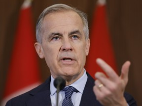Mark Carney gestures while speaking
