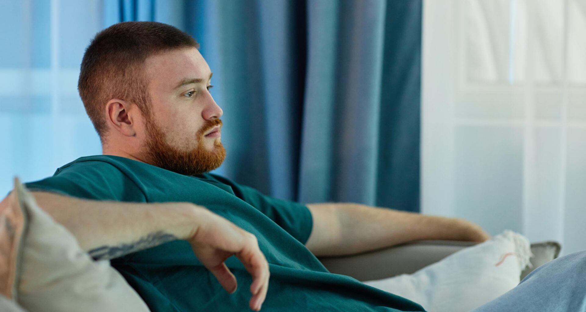Bored Lazy Man Sitting on Couch