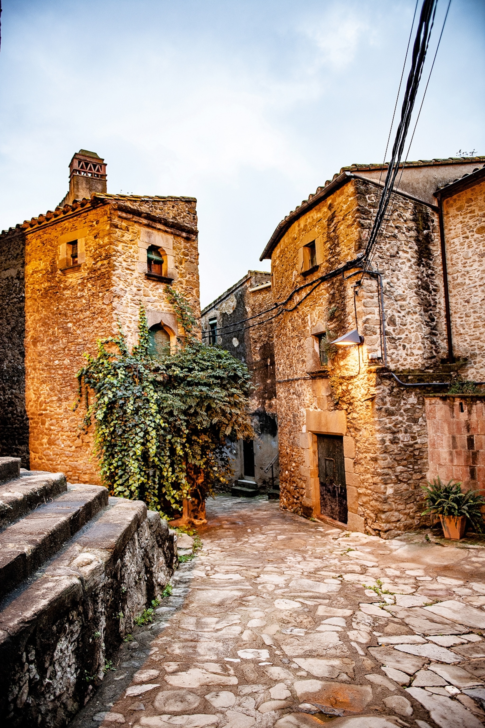 Empty cobbled street with stone buildings.