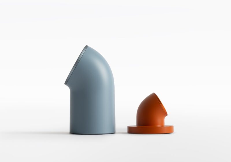 Two smooth, rounded DailyObjects with angled tops—one tall and blue-gray, the other shorter and orange—stand out against a plain white background.