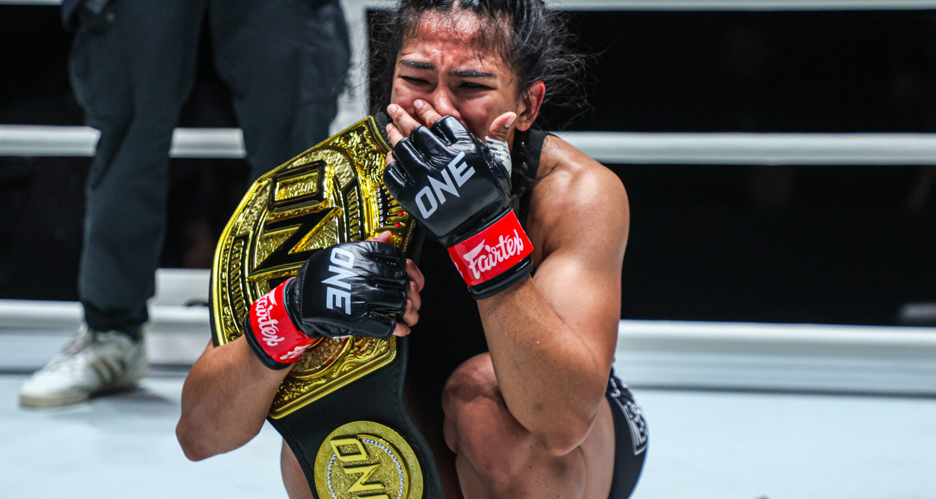 Denice Zamboanga in tears after capturing the interim atomweight MMA world title against Alyona Rassohyna.