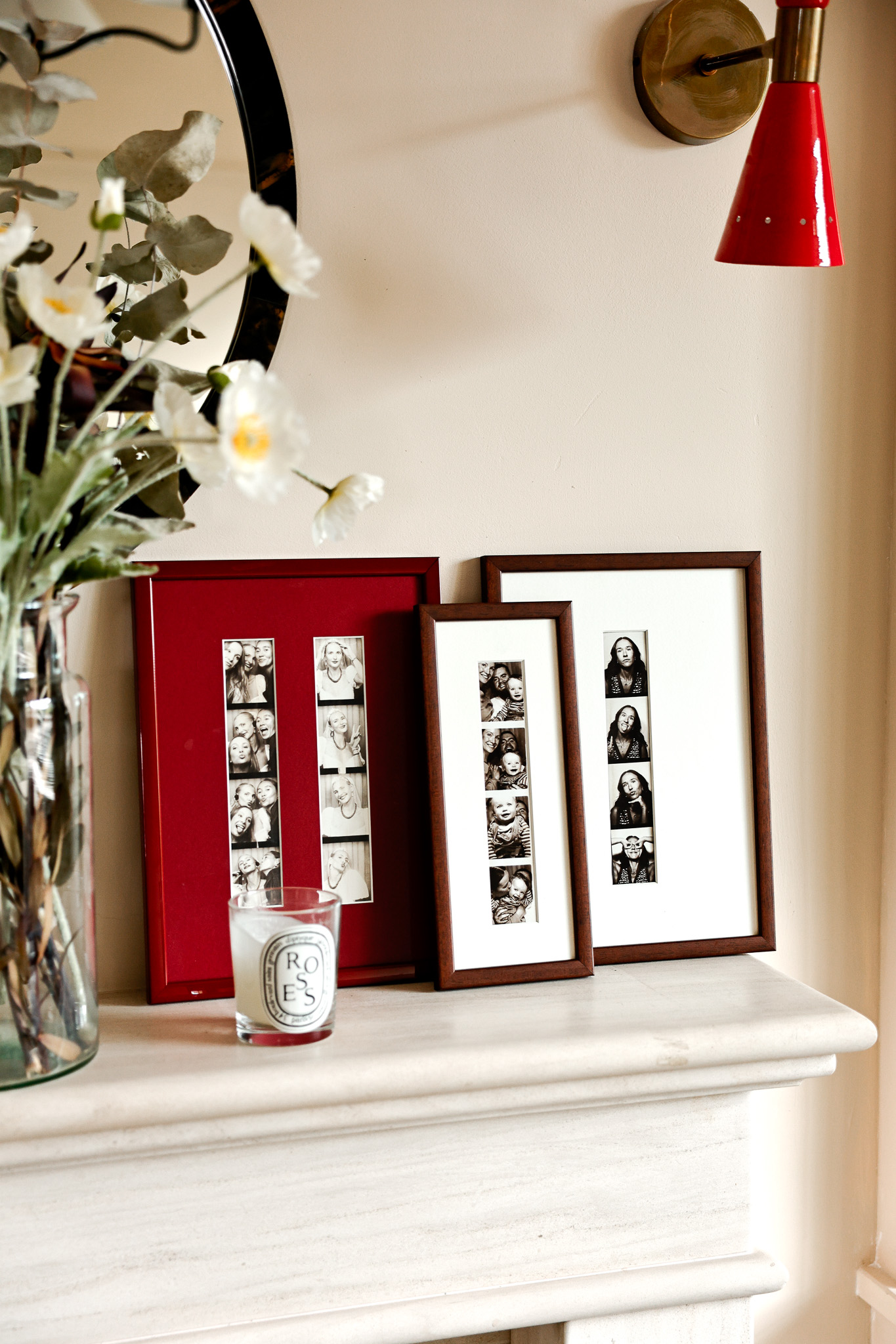 A mantel with a leaning cluster of three photo frames