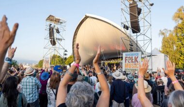 Audience members at the 2025 Vancouver Folk Music Festival clap their hands along to the music.
