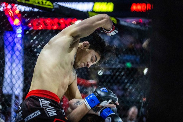 Andrew Alirez fights Bruce Martin, from Castle Rock, in Alirez's 140-pound debut MMA fight at Blue Federal Credit Union Arena in Loveland on Saturday, April 25, 2026. Alirez went on to win with a technical knockout after 43 seconds in the octagon. (Brice Tucker/Staff Photographer)