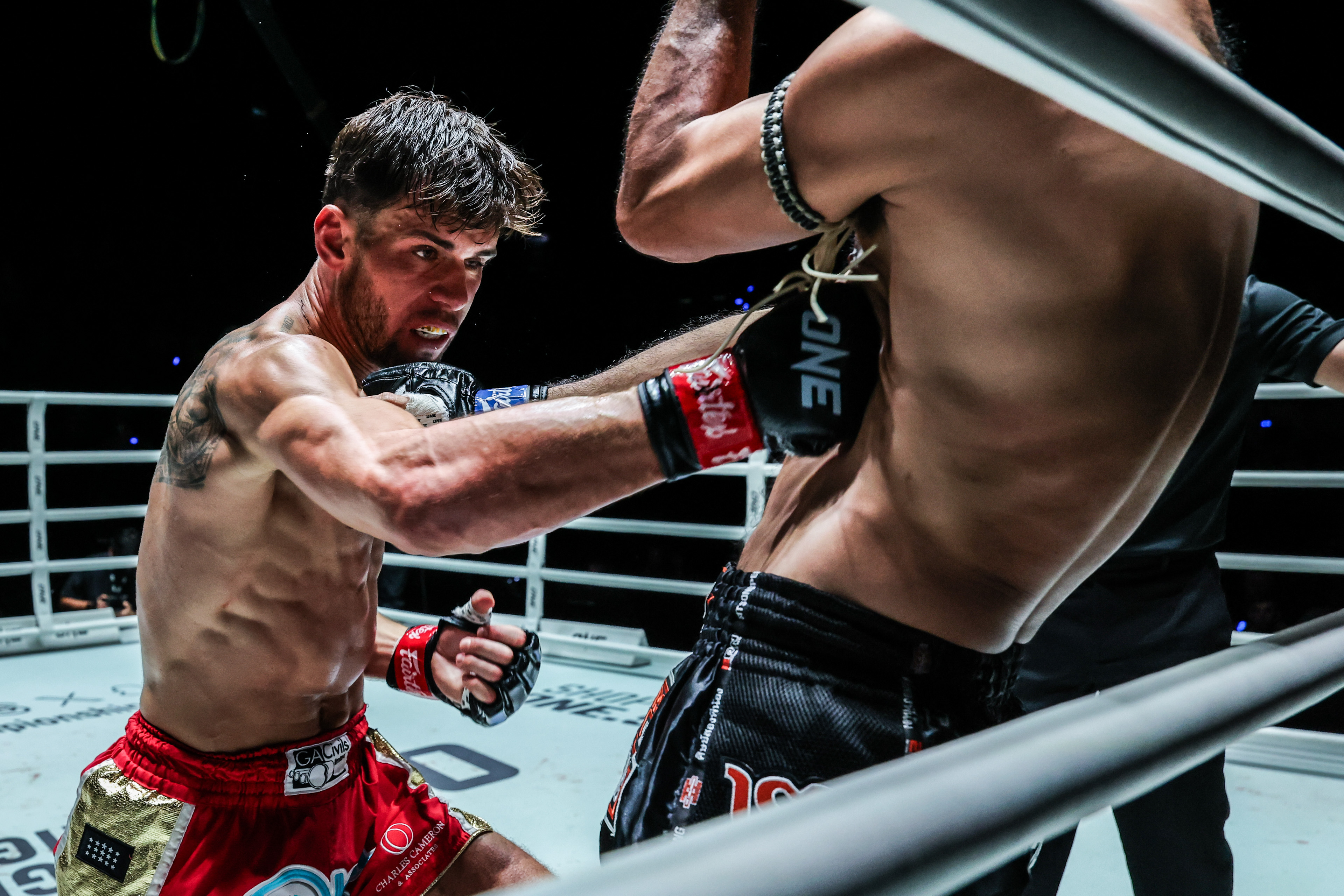British Muay Thai fighter George Jarvis punches Rungrawee Sitsongpeenong to the body
