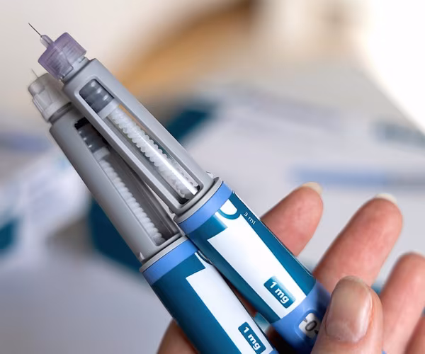 person holding GLP-1 injection pens