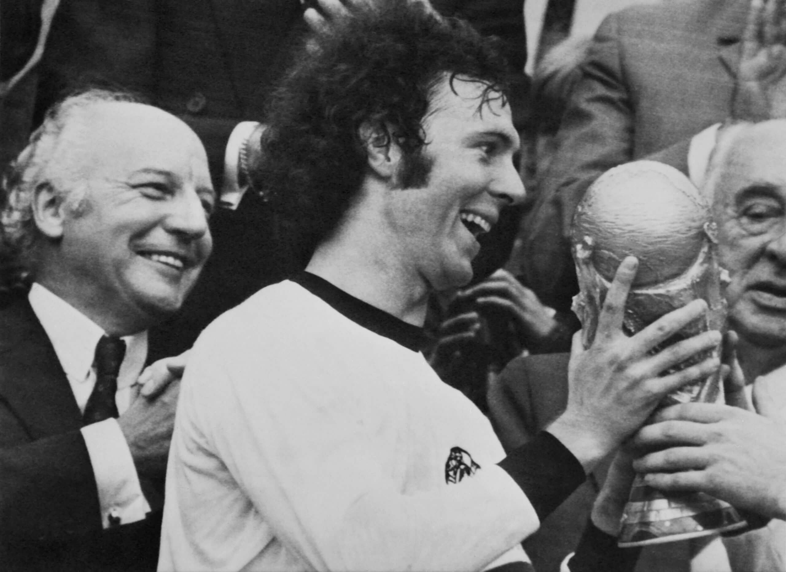 A delighted Franz Beckenbauer grasps the World Cup trophy in 1974