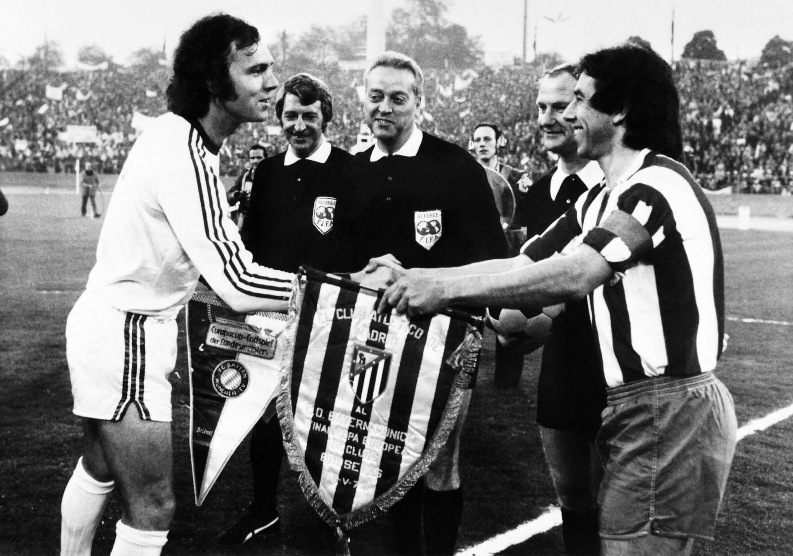 Franz Beckenbauer swaps pennants with Atletico Madrid's captain Abelardo ahead of the 1974 European Cup final in Brussels