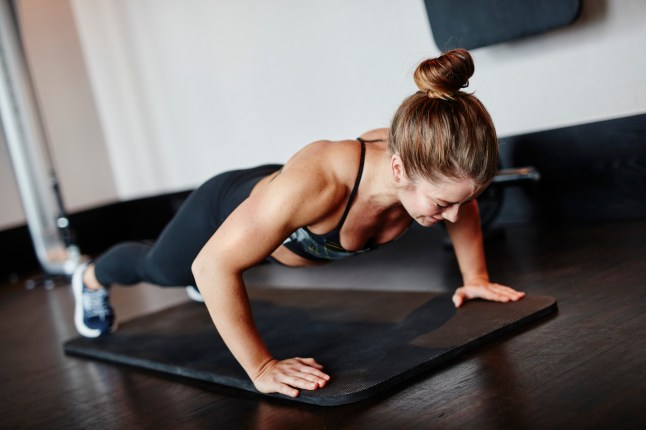 Woman doing push-ups in gym